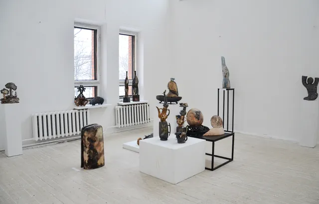 Sculptures arranged throughout a bright contemporary exhibition.
