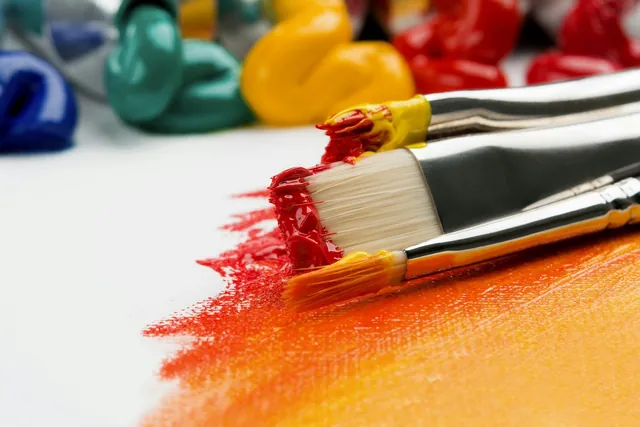 Representative art detail: paintbrushes with red and orange paint on a canvas; not an artwork or workshop at the listed venue.