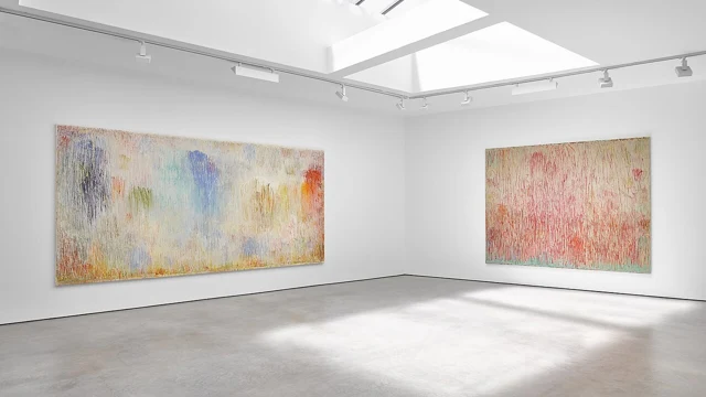 Two large paintings displayed in a bright contemporary gallery.