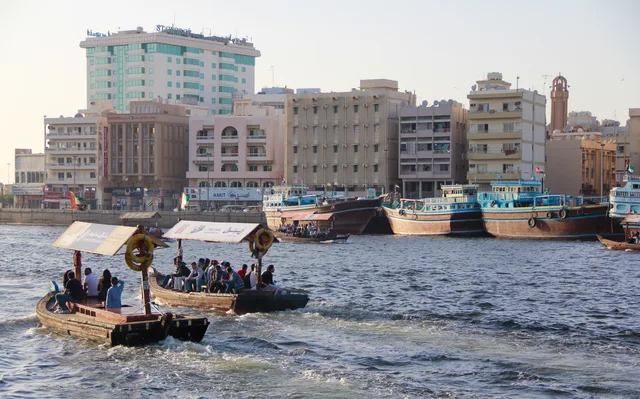 Traditional wooden boats and abras on Dubai Creek beside the old waterfront.
