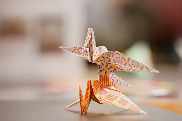 Colourful patterned paper cranes illustrating three-dimensional paper craft.