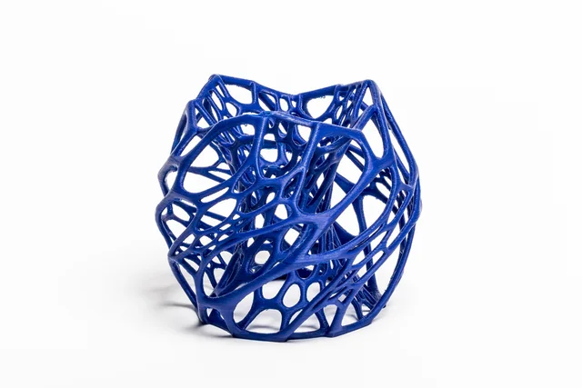 A blue, open-lattice three-dimensional design object on a white background.