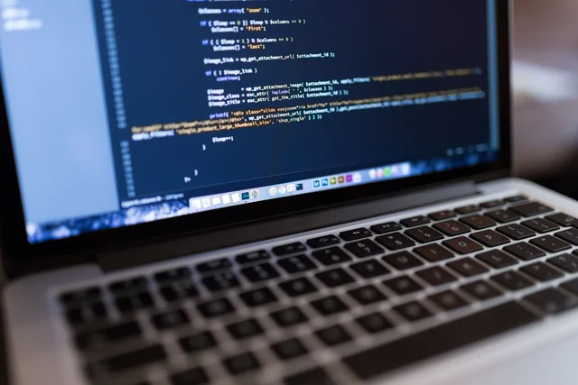 Representative close-up of programming code on a laptop screen.