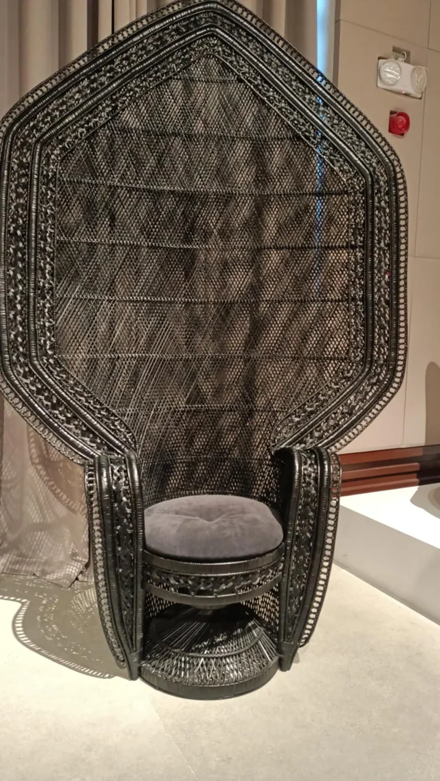 Representative sculptural Raina Peacock Chair with an intricately woven high back