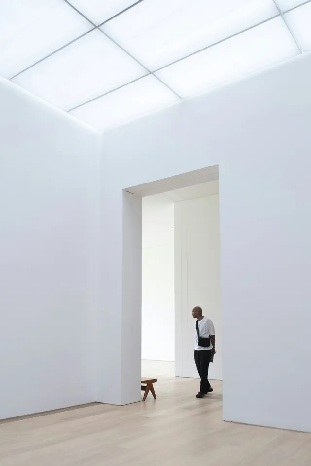 Representative gallery visit: a visitor framed by a tall doorway and white gallery walls; not the listed venue.