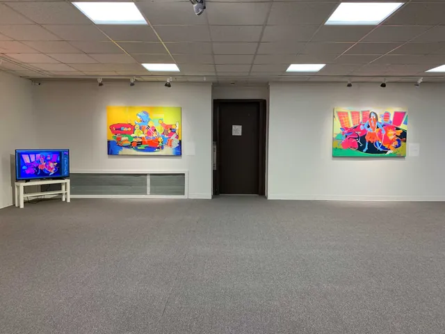 Colourful contemporary paintings in a gallery exhibition.