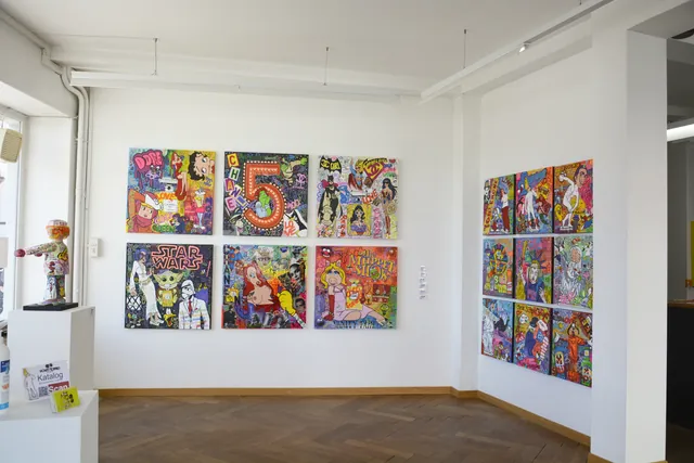 Colourful contemporary artworks displayed in a bright gallery.