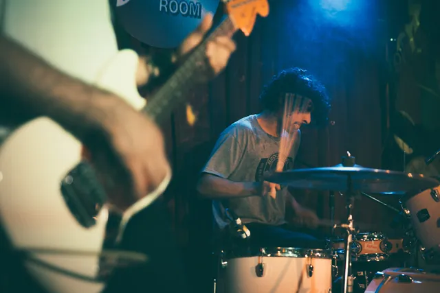 Musicians playing an intimate live music set.