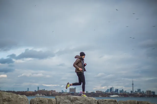 Running outside with city view in the background — representative activity photo