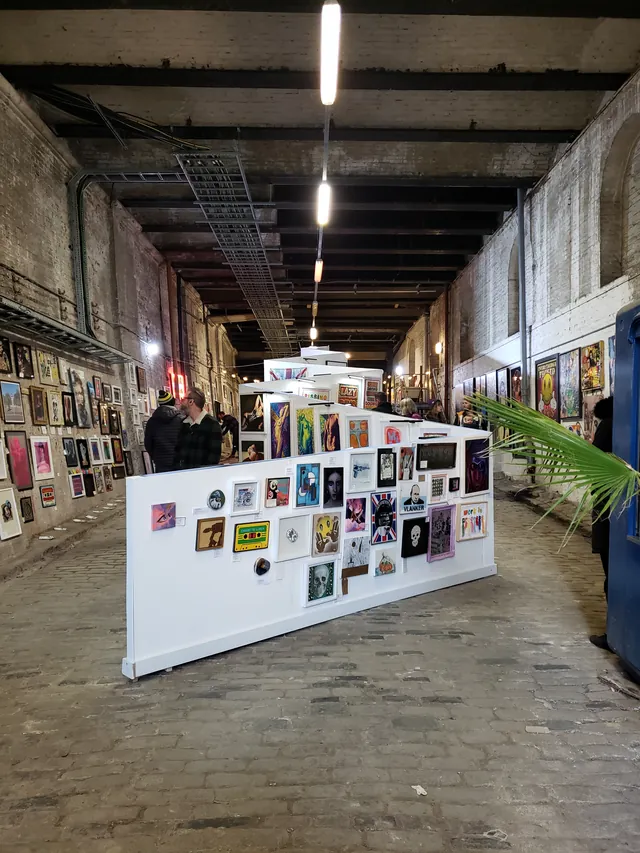 A contemporary art installation within a spacious industrial gallery.